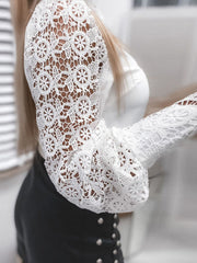 White lace long-sleeve button-down blouse with intricate floral pattern and bell sleeves.