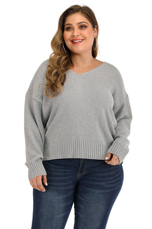 Plus size grey knit sweater with v-neck and ribbed cuffs and hem