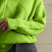 Yellow-green acrylic knit turtleneck sweater with diamond pattern and ribbed cuffs.