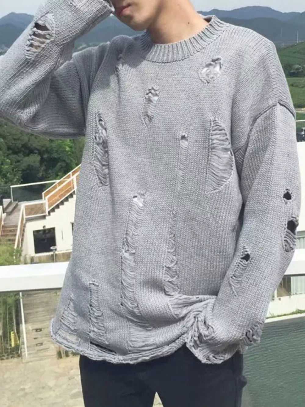Men's Distressed Round Neck Sweater in Black, model styling view