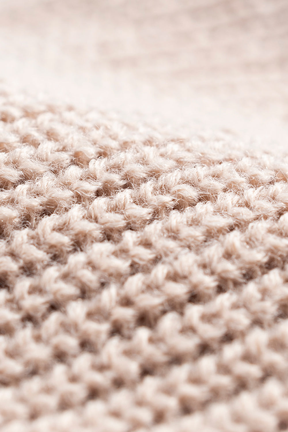 Tan ribbed knit beanie with a fuzzy acrylic texture