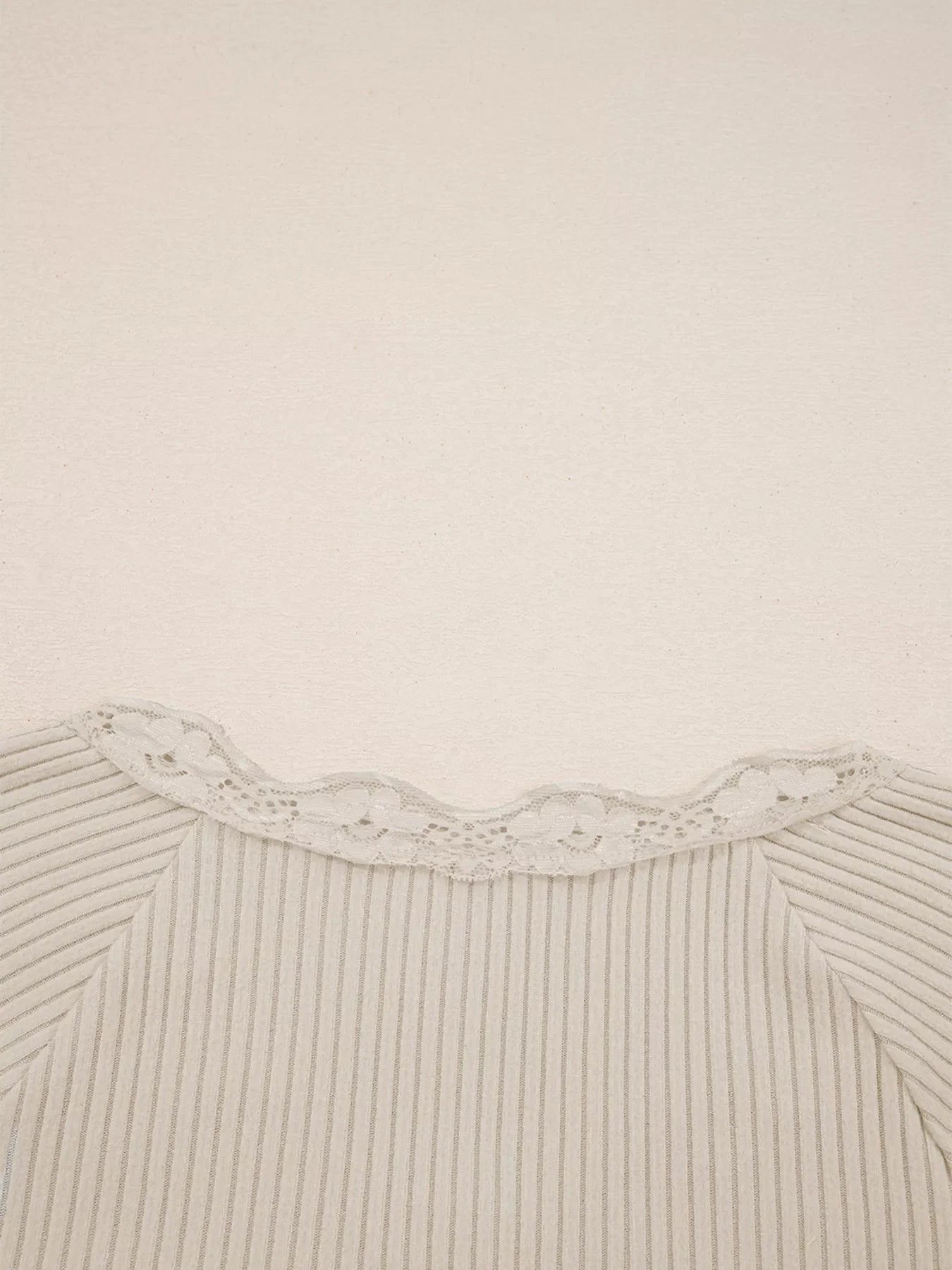 Beige ribbed long-sleeve top with delicate lace trim neckline.