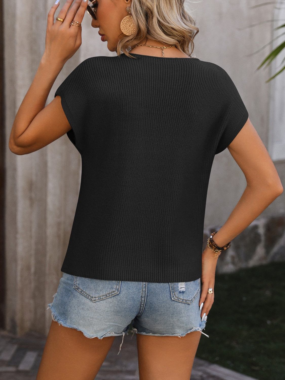 Black ribbed knit tee with short sleeves and a crew neck, made of acrylic.