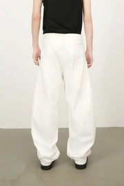 White wide leg trousers with sculpted pocket details and a relaxed fit.
