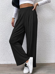 Black wide leg trousers with front pleats and a relaxed fit.