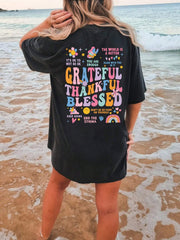 Black vintage wash graphic tee with colorful affirmation text and graphics.