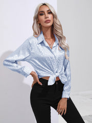 Light blue satin leopard print button-down shirt with a knotted hem.