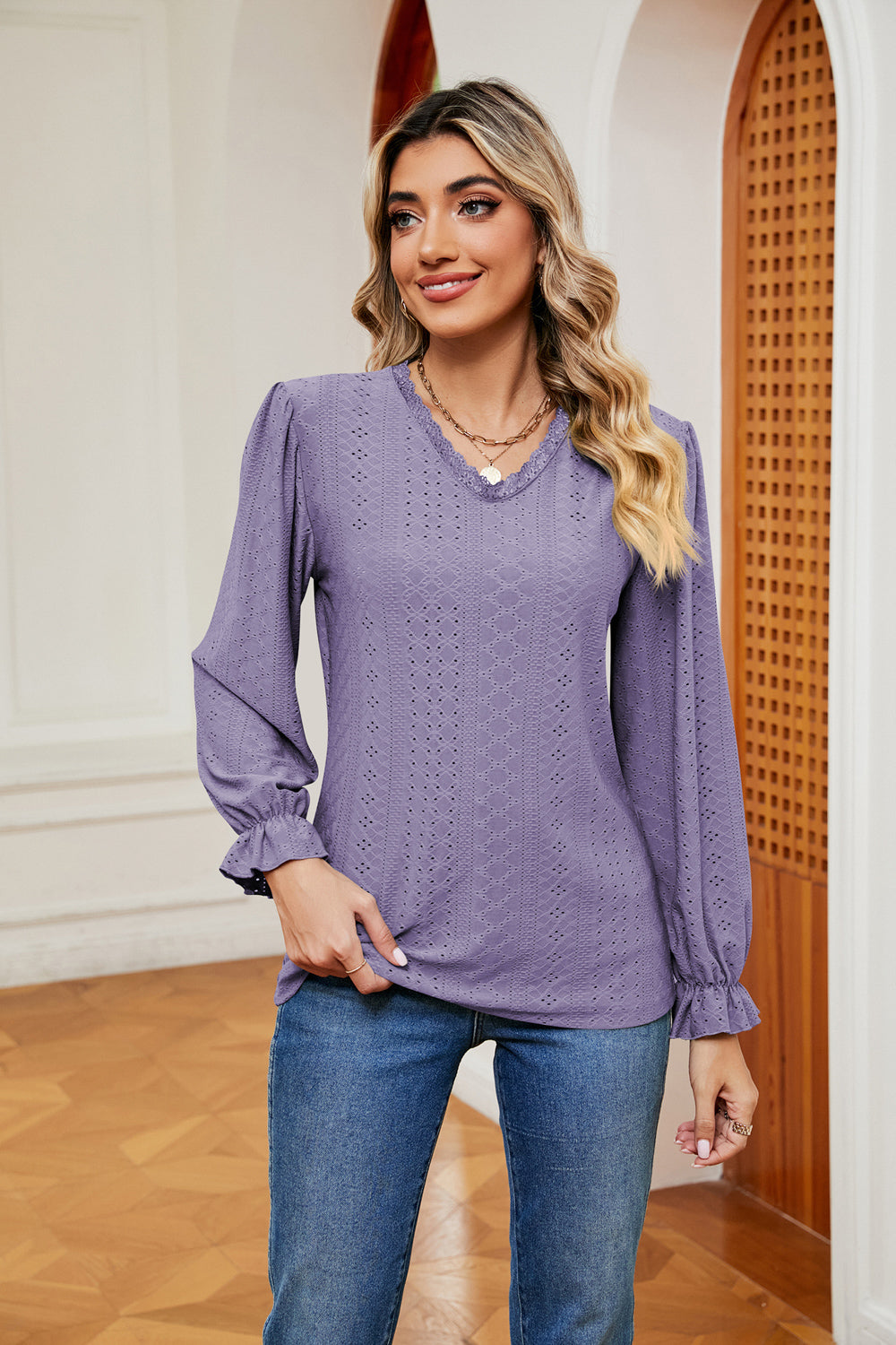 Lilac perforated sleeve blouse with ruffle cuffs and v-neckline.