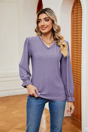 Lilac perforated sleeve blouse with ruffle cuffs and v-neckline.