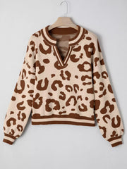 Chic leopard print knit sweater with notched neckline and striped trim.