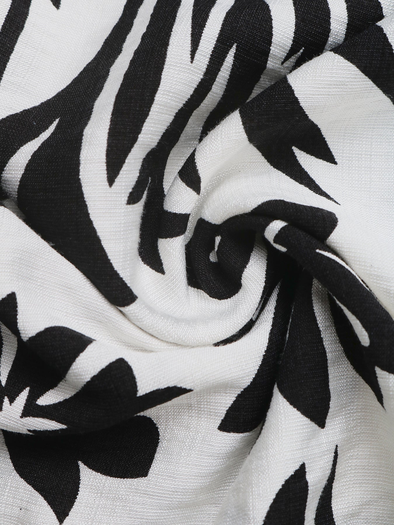 Maxi dress with black and white floral print, halter neck, and deep V.