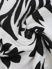 Maxi dress with black and white floral print, halter neck, and deep V.