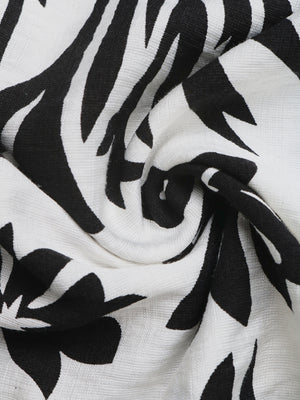 Maxi dress with black and white floral print, halter neck, and deep V.
