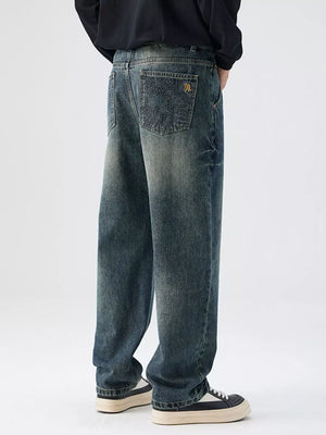 Relaxed fit vintage wash denim jeans with distressed details and embroidered back pocket.