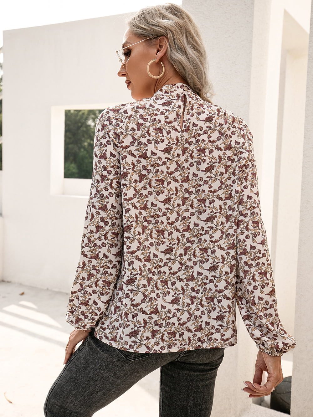 Floral blouse with gathered sleeves and keyhole neck detail.