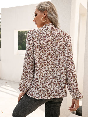 Floral blouse with gathered sleeves and keyhole neck detail.