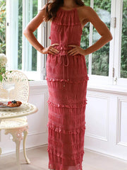 Brick-red halter neck smocked tiered maxi dress with ruffle trim and drawstring waist.