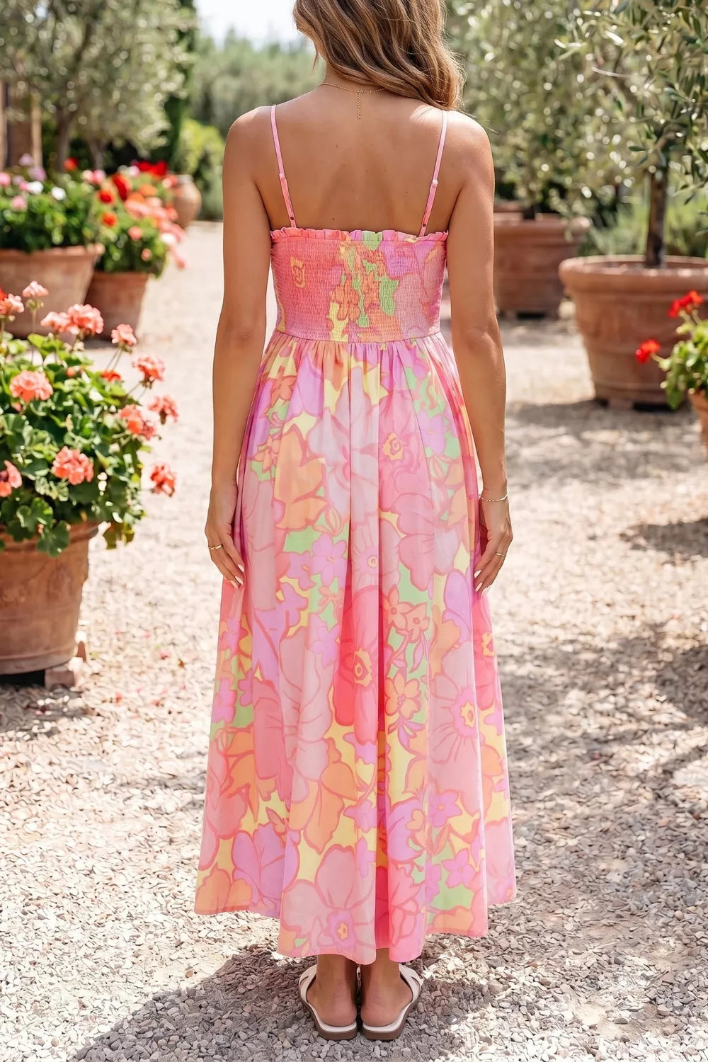 Floral smocked high waist midi dress in pink with a vibrant floral print and spaghetti straps.