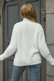 White fluffy mock neck sweater with long sleeves and ribbed cuffs.