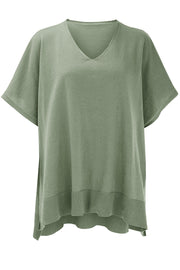 Sage green relaxed V-neck knit poncho top with short sleeves and ribbed hem.