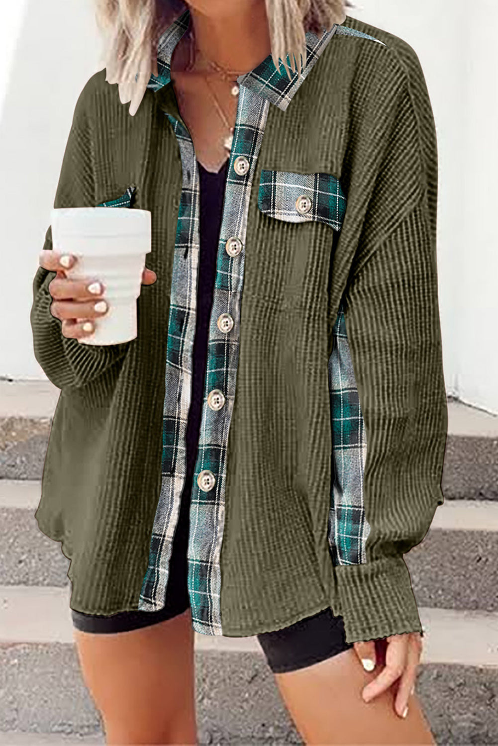 Green waffle knit overshirt with plaid trim and button front, styled open over a black tank top.
