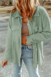 Sage green textured shacket with raw edge detailing and button closures.