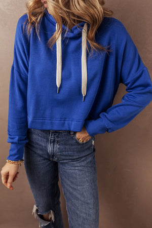 Cobalt cropped hoodie with contrast ties and a relaxed fit.