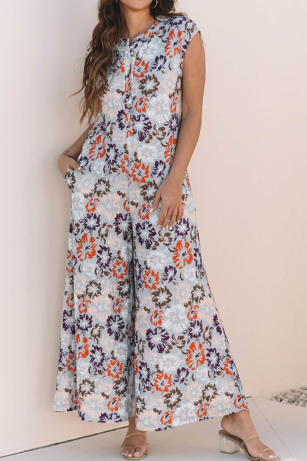 Floral cap-sleeve wide-leg jumpsuit with button detail and pockets