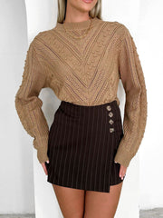 Camel textured chevron knit pullover sweater with bobble details and mock neck.