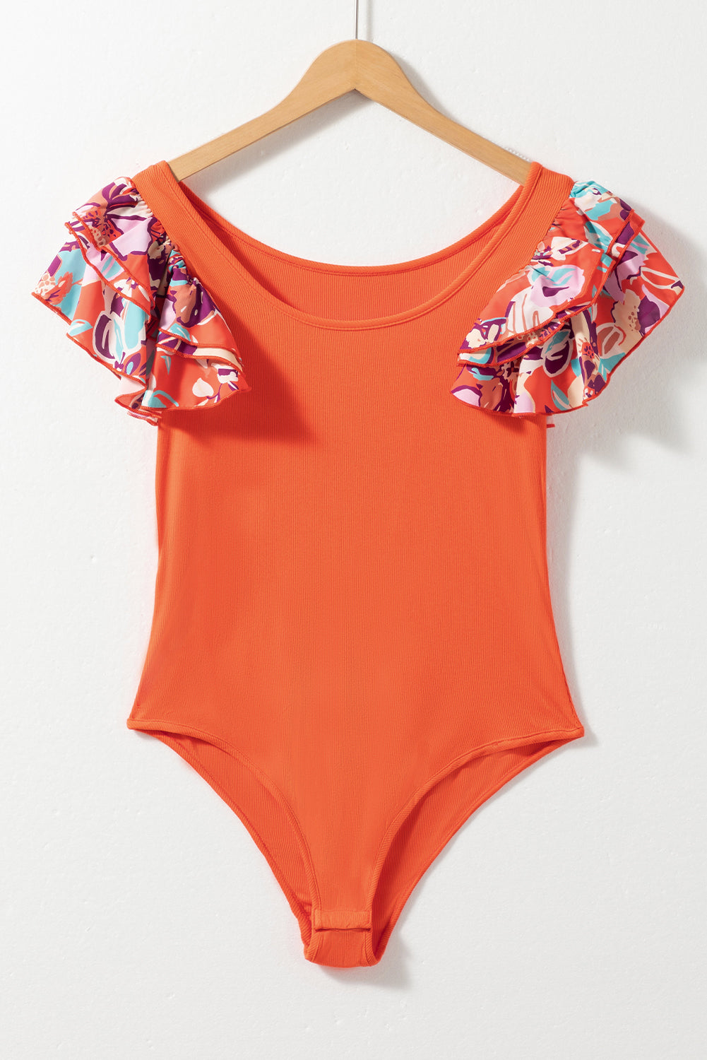 Orange-red ribbed bodysuit with floral ruffle sleeves and scoop neck.