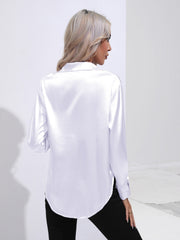White satin tie-front blouse with a collared neckline and long sleeves.