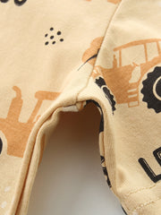 Toddler t-shirt in tan cotton with a playful tractor print and black dots.