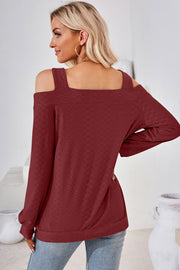 Burgundy geometric cutout shoulder top with long sleeves and a square neckline.
