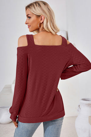 Burgundy geometric cutout shoulder top with long sleeves and a square neckline.