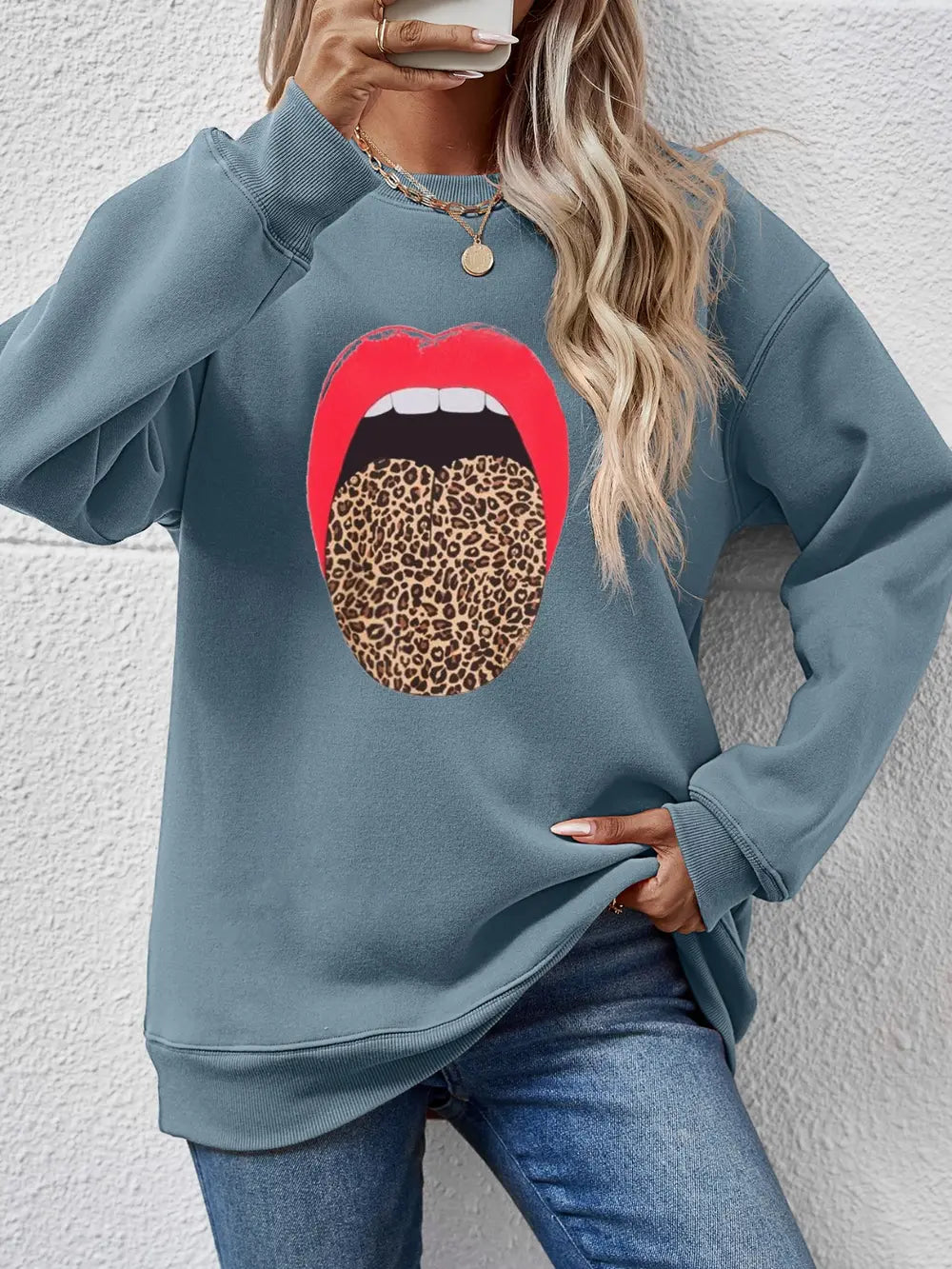 Light Blue sweatshirt with bold red lips and leopard tongue graphic.