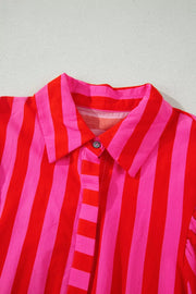 Vibrant puff sleeve stripe shirt in red and pink cotton blend with button front.
