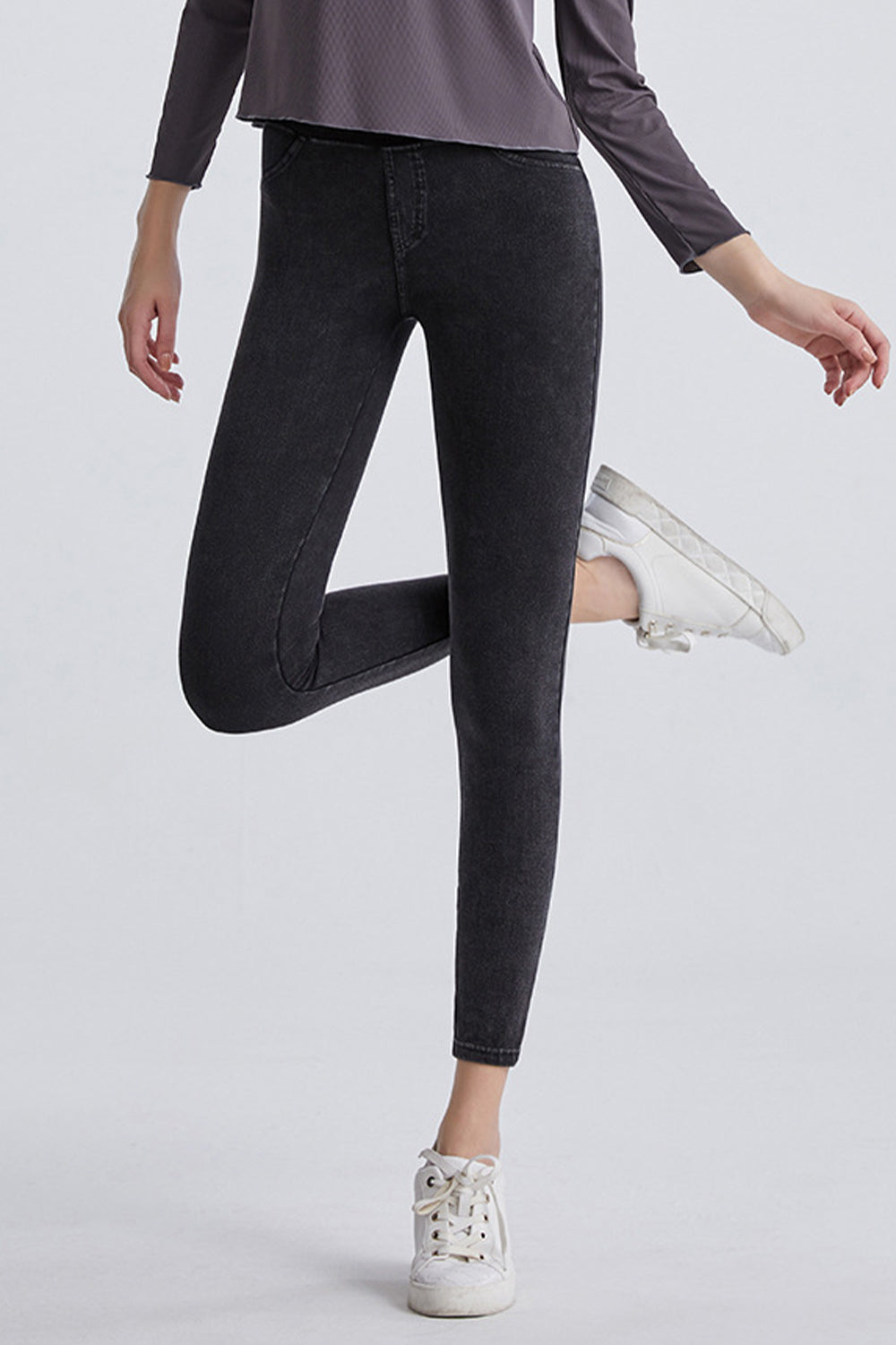 Dark gray denim leggings with faux pockets and a high waist.