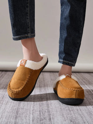 Caramel suede moccasin slides with shearling lining and decorative stitching.