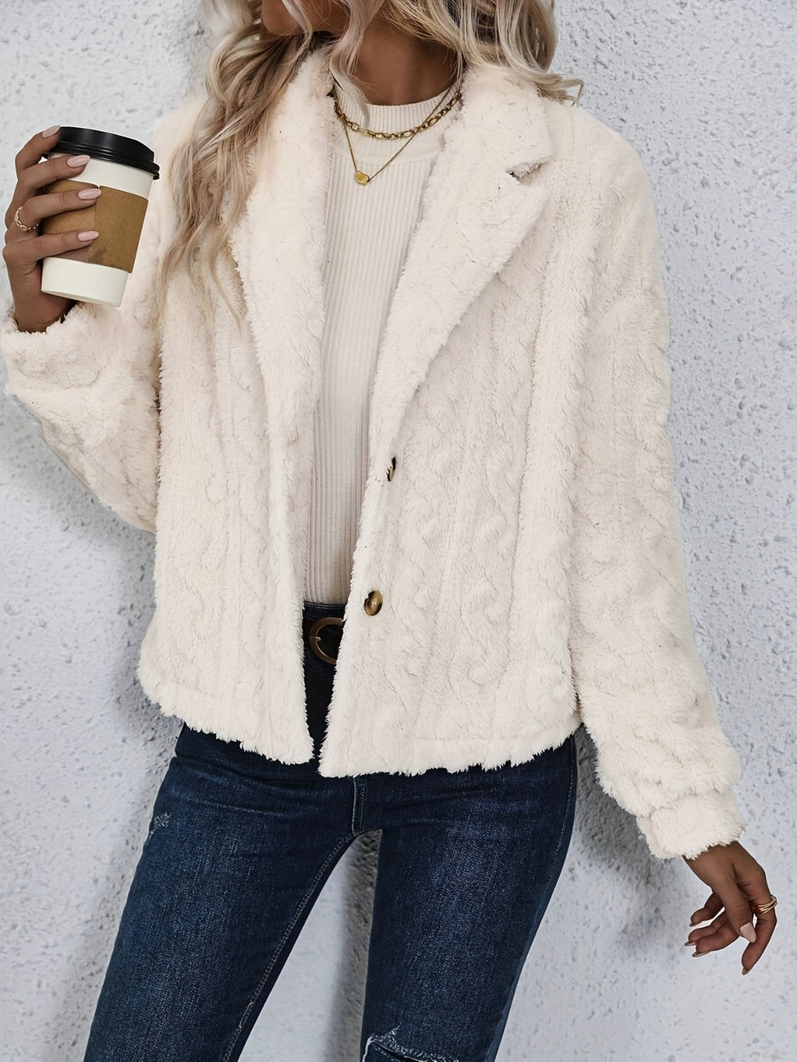 Cream textured teddy bear blazer with button closure and notched lapels.