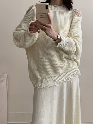 Off white distressed cotton sweater with cut-out shoulders and frayed hem.