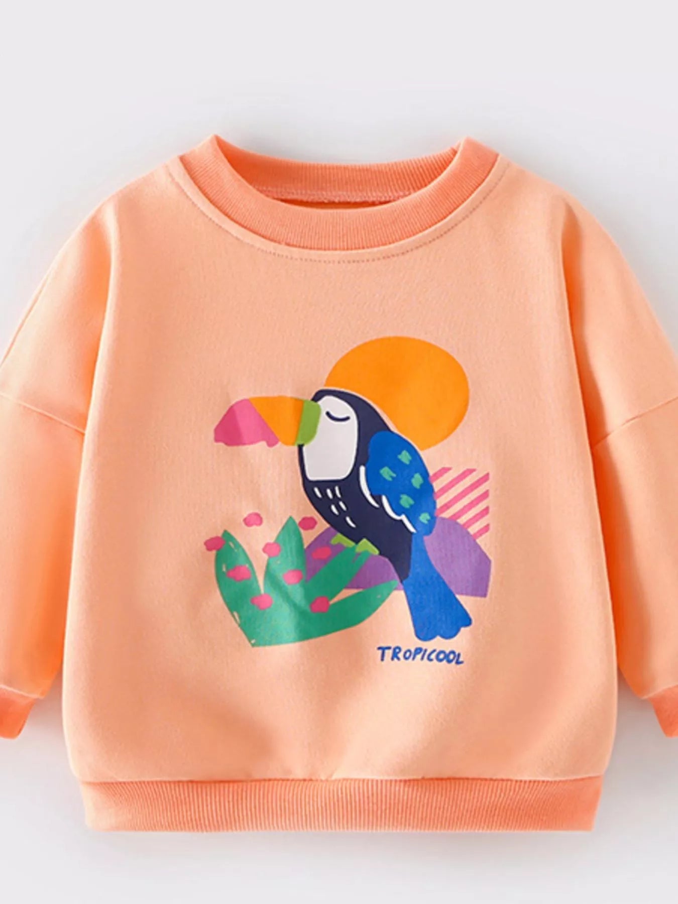 Tangerine crew neck sweatshirt for kids with a toucan graphic and "TROPICOOL" text.