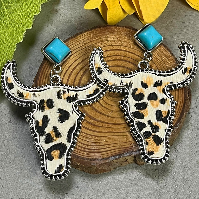 Cowhide bull head earrings with leopard print and turquoise studs.