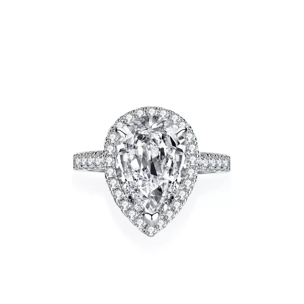 Elegant sterling silver ring with a brilliant pear-shaped moissanite center stone and halo detail.