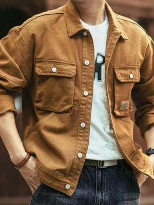 Brown washed cotton chore jacket with four front utility pockets and button closure.