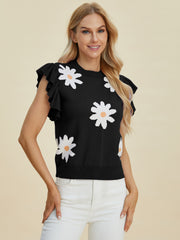 Black knit blouse with white daisy print and ruffled short sleeves