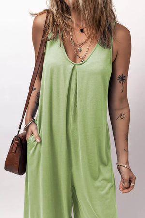 Sleeveless wide-leg romper in light green with V-neck and pockets.