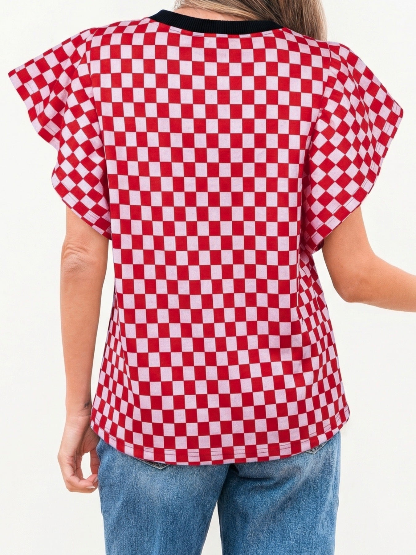 Red and white checkered print shirt with ruffle sleeves and a black neckline.