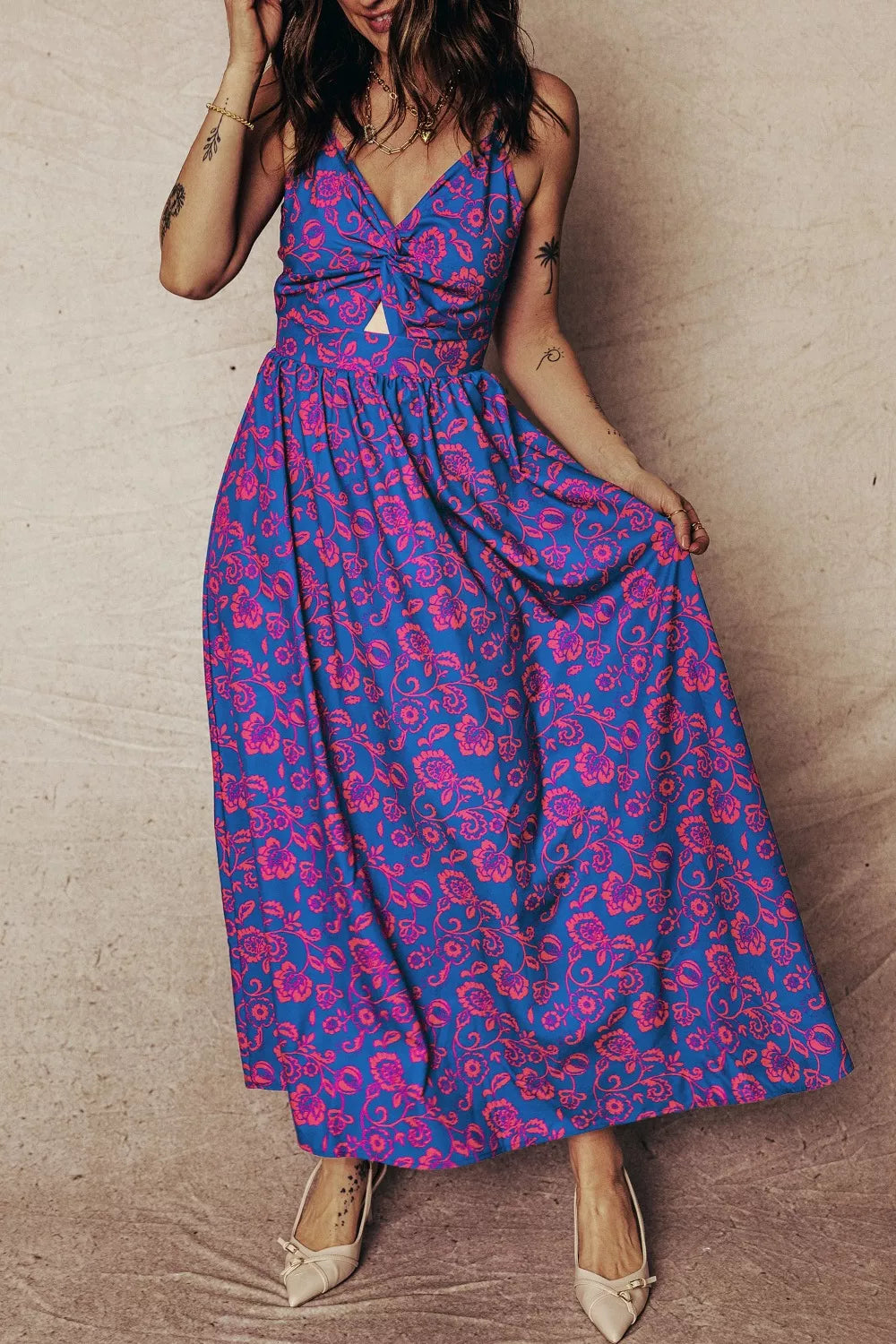 Blue floral maxi dress with cutout detail and twisted front.