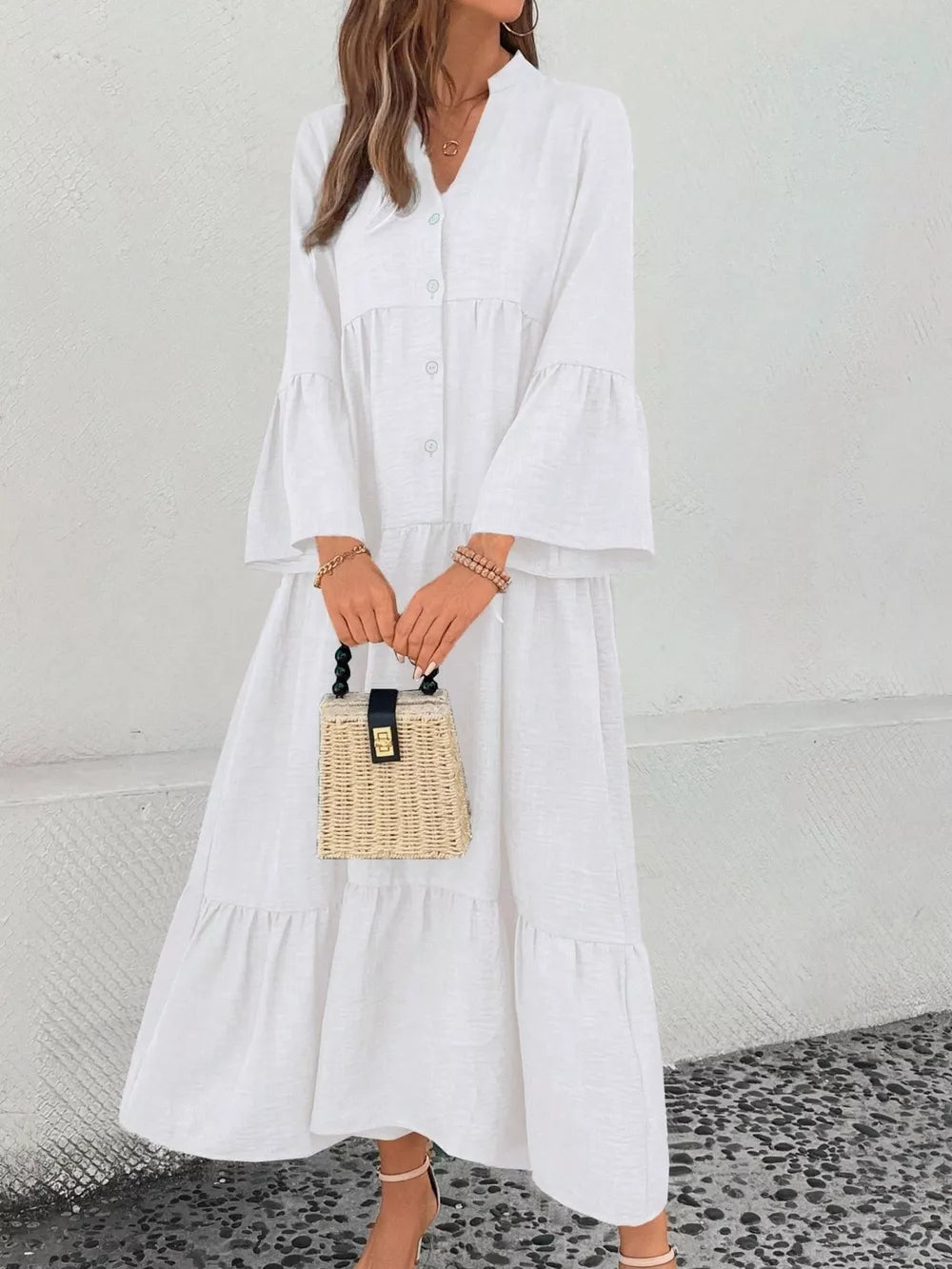 White tiered ruffle hem v-neck dress with button front and bell sleeves.