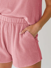Chic sleeveless coord set in blush pink with ribbed texture and elastic waist shorts.